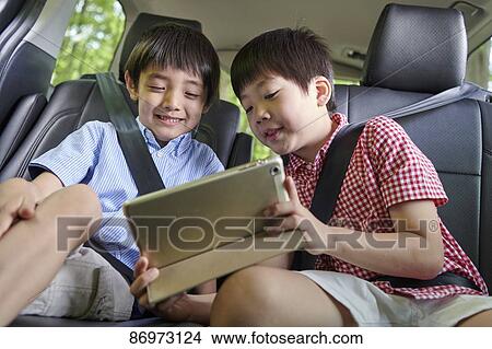 Picture - Japanese kids in the car. Fotosearch