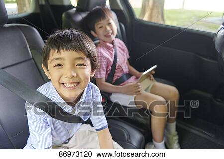 Stock Image - Japanese kids in the car. Fotosearch