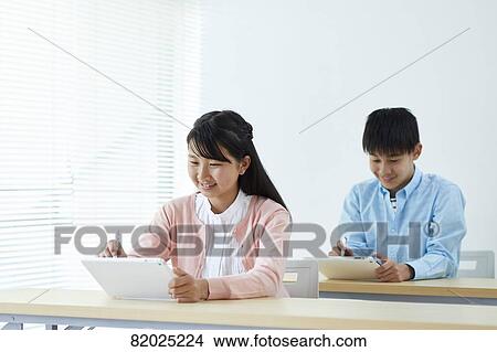 Picture - Japanese kids studying. Fotosearch