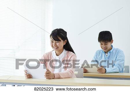 Stock Image - Japanese kids studying. Fotosearch