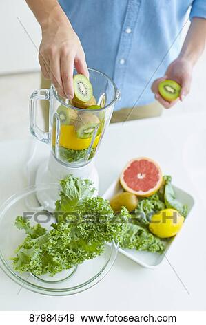 Japanese man making smoothie in the kitchen View Large Photo Image Stock Photo - Japanese man making smoothie in the kitchen. Fotosearch