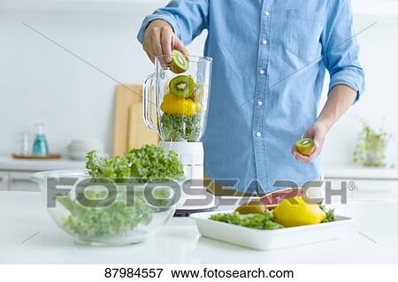 Japanese man making smoothie in the kitchen View Large Photo Image Stock Photo - Japanese man making smoothie in the kitchen. Fotosearch