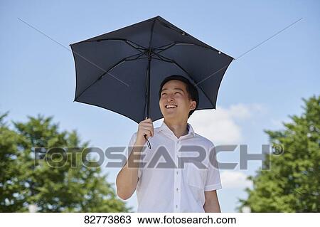 Stock Image - Japanese man with parasol. Fotosearch