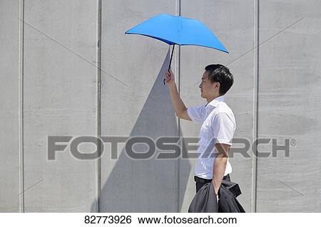 Stock Photograph - Japanese man with parasol. Fotosearch