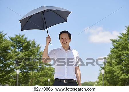 Stock Photography - Japanese man with parasol. Fotosearch