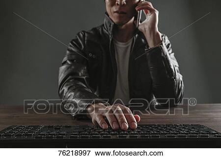 Stock Photo - Japanese man working with keyboard. Fotosearch