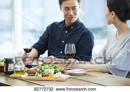 Stock Image - Japanese mature couple eating. Fotosearch