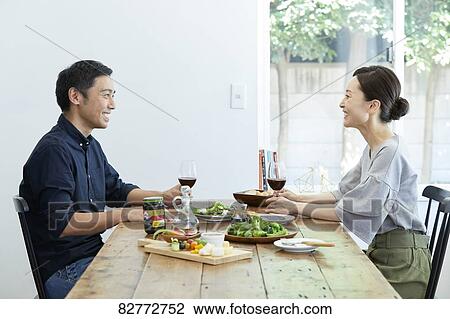 Stock Image - Japanese mature couple eating. Fotosearch