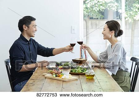 Stock Image - Japanese mature couple eating. Fotosearch