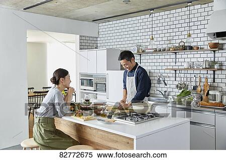 Stock Photography - Japanese mature couple in the kitchen. Fotosearch