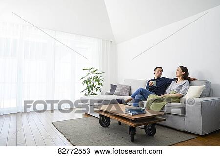 Stock Image - Japanese mature couple on the sofa. Fotosearch