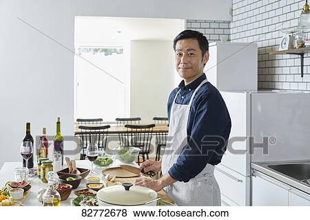 Japanese mature man in the kitchen View Large Photo Image Stock Photo - Japanese mature man in the kitchen. Fotosearch