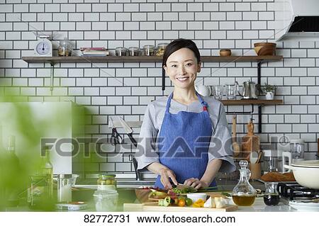Japanese mature woman in the kitchen View Large Photo Image Stock Image - Japanese mature woman in the kitchen. Fotosearch