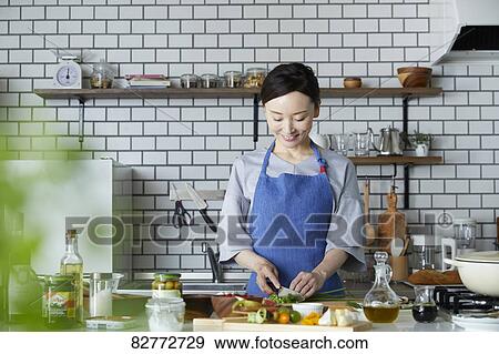 Japanese Mature Woman In The Kitchen Stock Photo Fotosearch