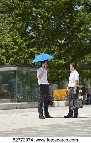 Picture - Japanese men with parasol. Fotosearch