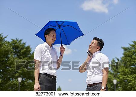 Japanese men with parasol View Large Photo Image Stock Image - Japanese men with parasol. Fotosearch