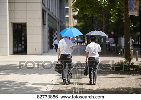 Stock Photograph - Japanese men with parasol. Fotosearch