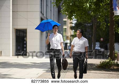Stock Photography - Japanese men with parasol. Fotosearch