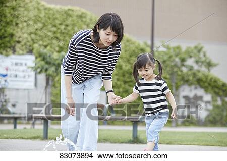 Japanese mother and daughter at a city park View Large Photo Image Picture - Japanese mother and daughter at a city park. Fotosearch
