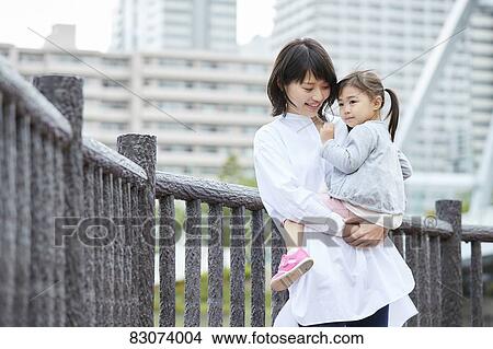 Japanese mother and daughter at a city park View Large Photo Image Picture - Japanese mother and daughter at a city park. Fotosearch