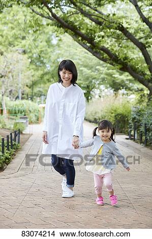 Japanese mother and daughter at a city park View Large Photo Image Picture - Japanese mother and daughter at a city park. Fotosearch