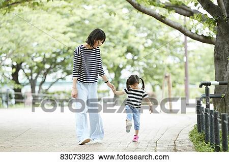 Japanese mother and daughter at a city park View Large Photo Image Stock Image - Japanese mother and daughter at a city park. Fotosearch