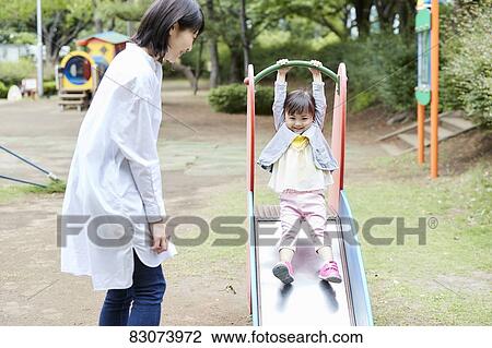 Japanese mother and daughter at a city park View Large Photo Image Stock Image - Japanese mother and daughter at a city park. Fotosearch