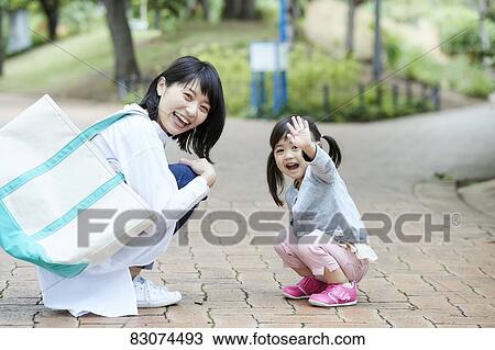 Japanese mother and daughter at a city park View Large Photo Image Stock Image - Japanese mother and daughter at a city park. Fotosearch