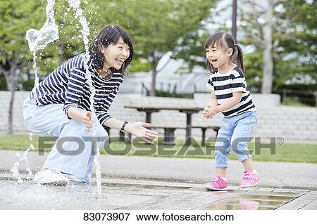 Japanese mother and daughter at a city park View Large Photo Image Stock Photo - Japanese mother and daughter at a city park. Fotosearch