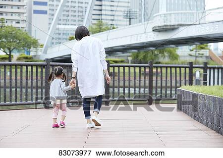 Japanese mother and daughter at a city park View Large Photo Image Stock Photo - Japanese mother and daughter at a city park. Fotosearch