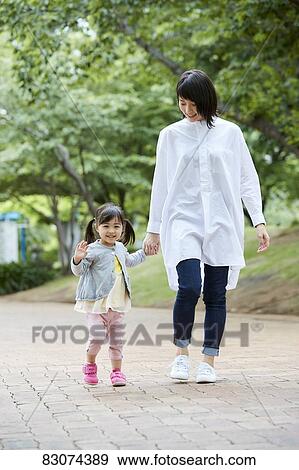 Japanese mother and daughter at a city park View Large Photo Image Stock Photo - Japanese mother and daughter at a city park. Fotosearch