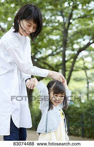 Japanese mother and daughter at a city park View Large Photo Image Stock Photo - Japanese mother and daughter at a city park. Fotosearch