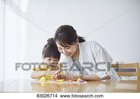 Picture - Japanese mother and kid playing. Fotosearch