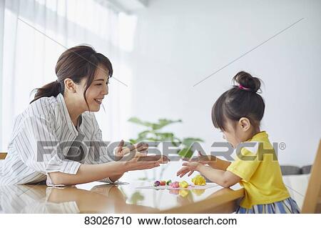 Stock Image - Japanese mother and kid playing. Fotosearch