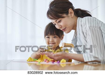 Stock Image - Japanese mother and kid playing. Fotosearch
