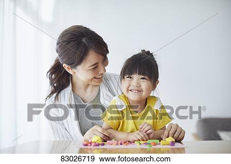 Stock Photo - Japanese mother and kid playing. Fotosearch