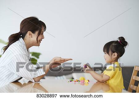 Stock Photo - Japanese mother and kid playing. Fotosearch
