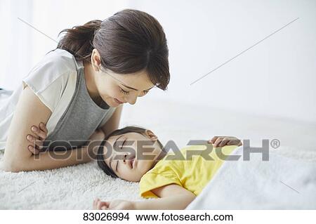 Japanese mother with sleeping kid View Large Photo Image Picture - Japanese mother with sleeping kid. Fotosearch