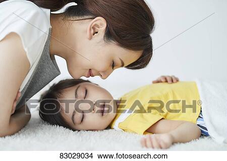 Japanese mother with sleeping kid View Large Photo Image Picture - Japanese mother with sleeping kid. Fotosearch