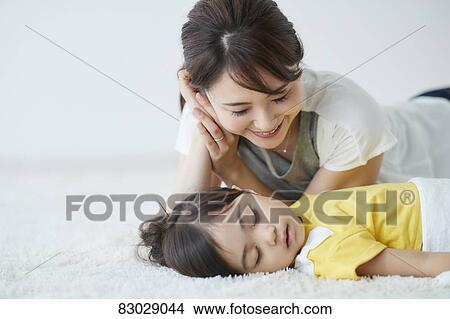 Japanese mother with sleeping kid View Large Photo Image Picture - Japanese mother with sleeping kid. Fotosearch