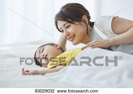 Japanese mother with sleeping kid View Large Photo Image Stock Image - Japanese mother with sleeping kid. Fotosearch