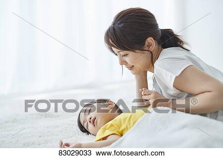 Japanese mother with sleeping kid View Large Photo Image Stock Image - Japanese mother with sleeping kid. Fotosearch