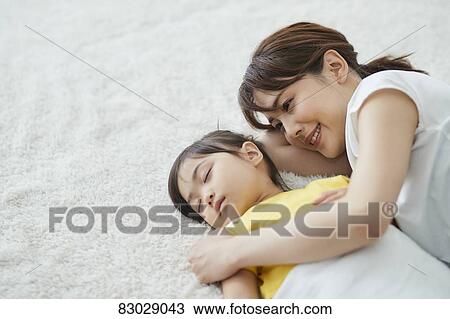 Japanese mother with sleeping kid View Large Photo Image Stock Image - Japanese mother with sleeping kid. Fotosearch