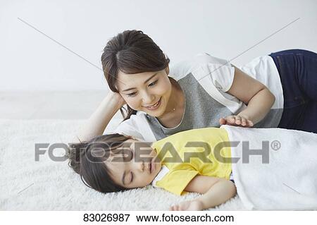 Japanese mother with sleeping kid View Large Photo Image Stock Photo - Japanese mother with sleeping kid. Fotosearch