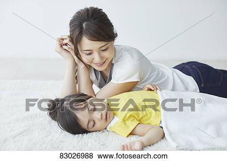 Japanese mother with sleeping kid View Large Photo Image Stock Photo - Japanese mother with sleeping kid. Fotosearch