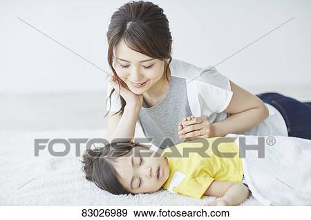 Japanese mother with sleeping kid View Large Photo Image Stock Photo - Japanese mother with sleeping kid. Fotosearch