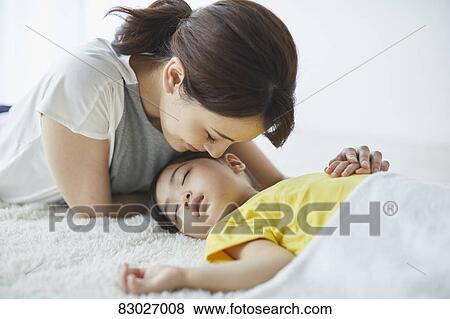 Japanese mother with sleeping kid View Large Photo Image Stock Photo - Japanese mother with sleeping kid. Fotosearch