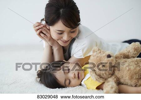 Japanese mother with sleeping kid View Large Photo Image Stock Photo - Japanese mother with sleeping kid. Fotosearch
