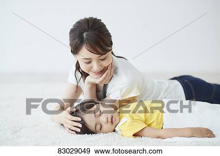 Japanese mother with sleeping kid View Large Photo Image Stock Photo - Japanese mother with sleeping kid. Fotosearch