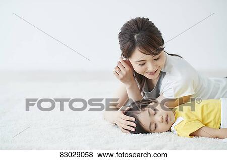 Japanese mother with sleeping kid View Large Photo Image Stock Photo - Japanese mother with sleeping kid. Fotosearch